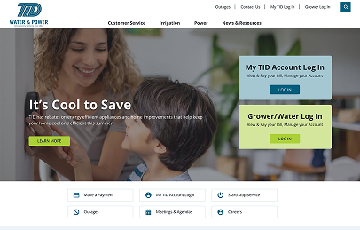 A woman and a child smile in a kitchen. The website promotes saving energy, with login options for TID and Grower/Water accounts, and links for payments, outages, and other services.
