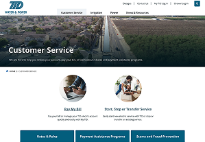 Customer service webpage for TID Water & Power, showing navigation tabs and two main options: pay bill and start, stop, or transfer service, with aerial view of a residential area in the header.