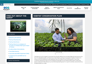 Two people stand in a green field examining plants, with a wind turbine visible in the background. The webpage is about a habitat conservation plan.