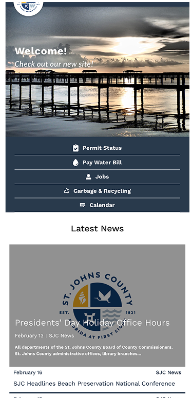 Screenshot of a county website homepage with navigation options, a water scene header, and news about holiday office hours and beach preservation.