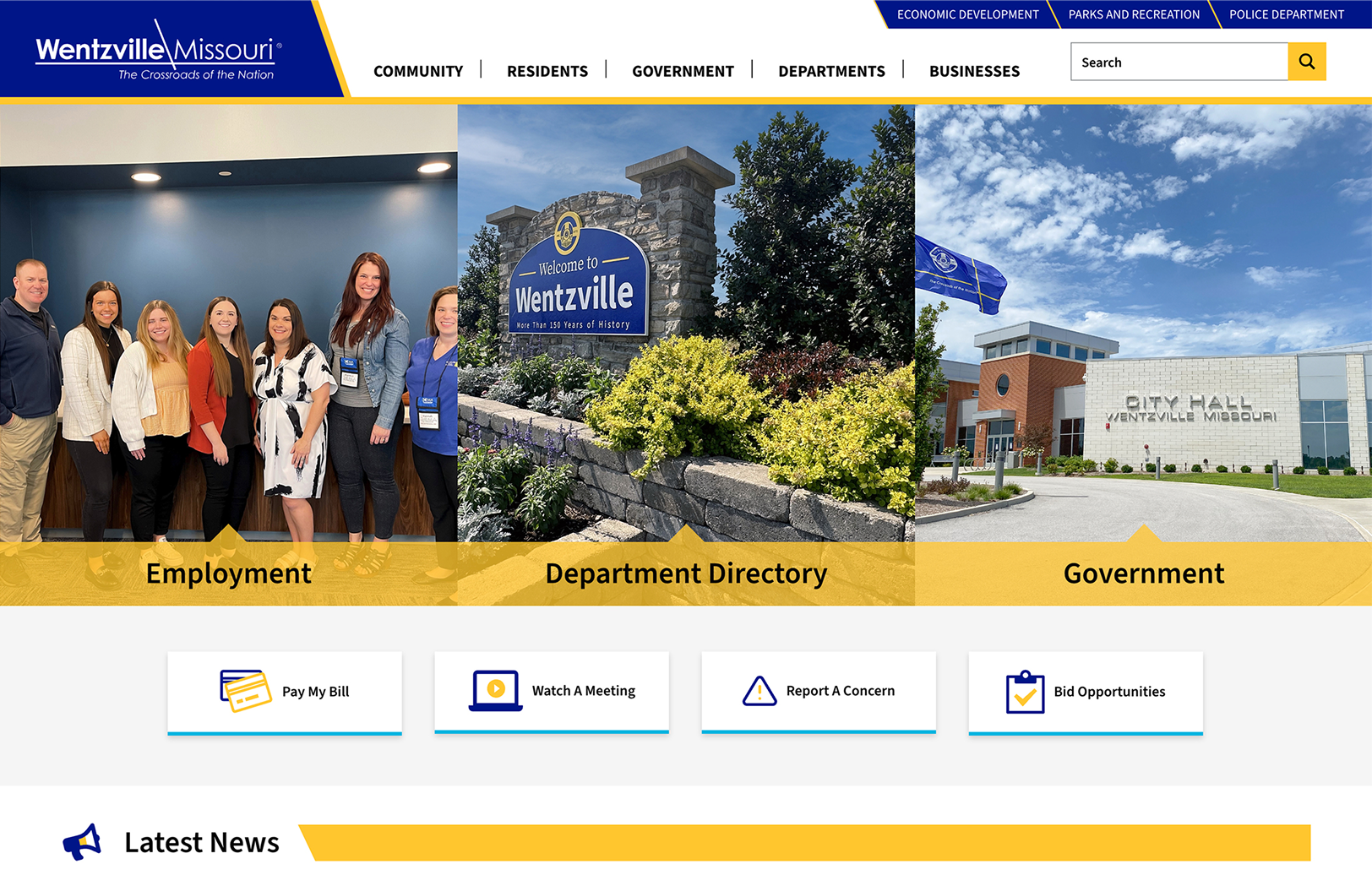 Wentzville, Missouri city website homepage displaying images of staff, a city welcome sign, and City Hall, with navigation options for Employment, Department Directory, and Government.