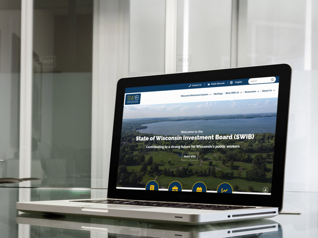 A laptop on a glass desk displays the homepage of the State of Wisconsin Investment Board (SWIB) website in a modern office setting.