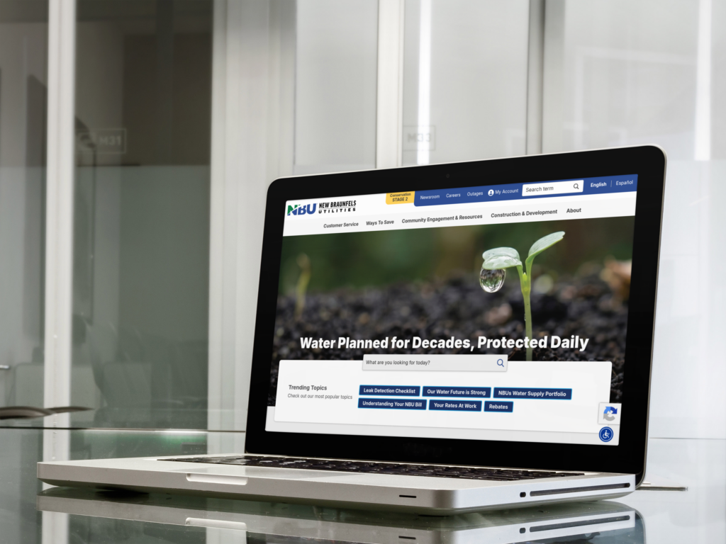 A laptop on a glass table displays a website about water resources, featuring a close-up photo of a plant with a water droplet and the headline "Water Planned for Decades, Protected Daily.